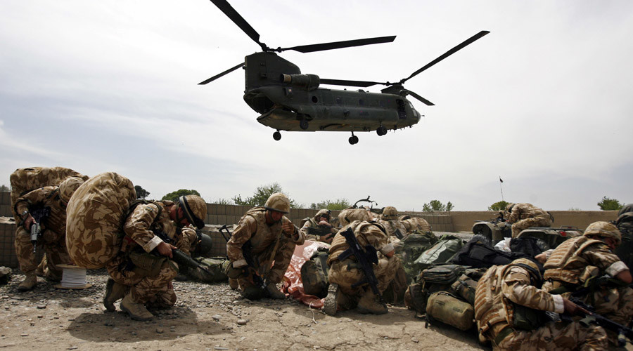 British soldiers take cover as a helicopter lands at Musa Qala in Helmand province, Afghanistan.
