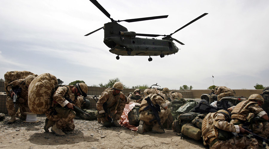 Click to enlarge British soldiers take cover as a helicopter lands at Musa Qala in Helmand province, Afghanistan.