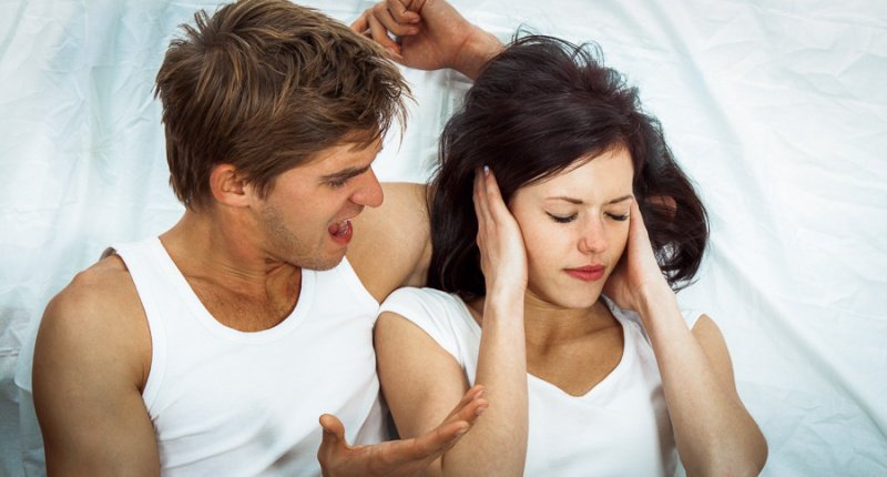 Young couple arguing in bed 