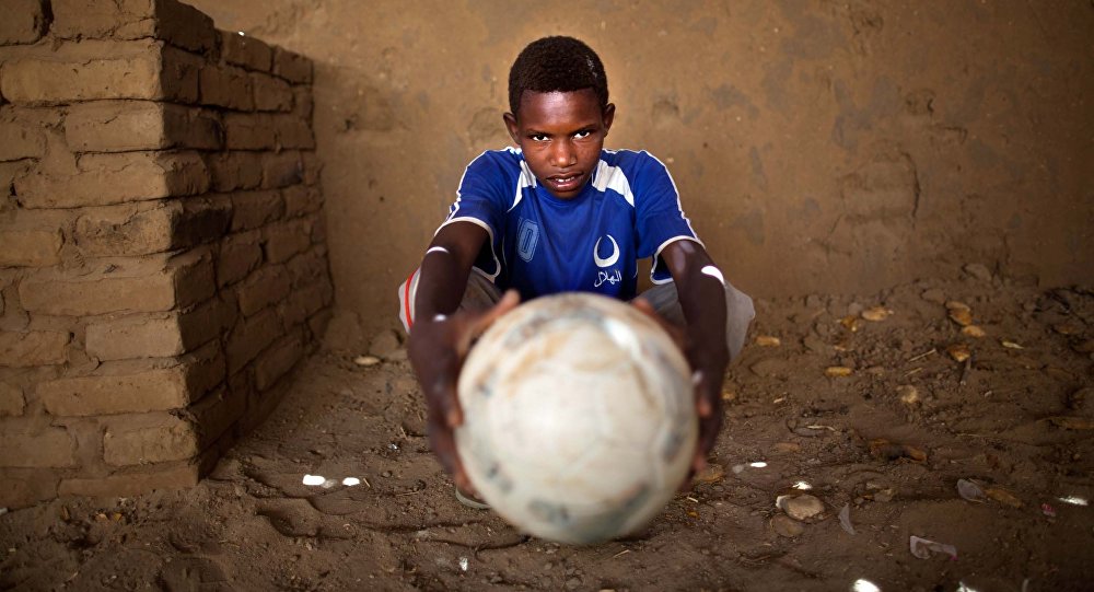 young african boy with football