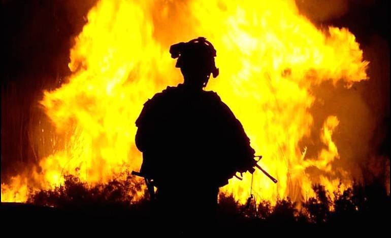 Click to enlarge soldier in front of fire war on terror