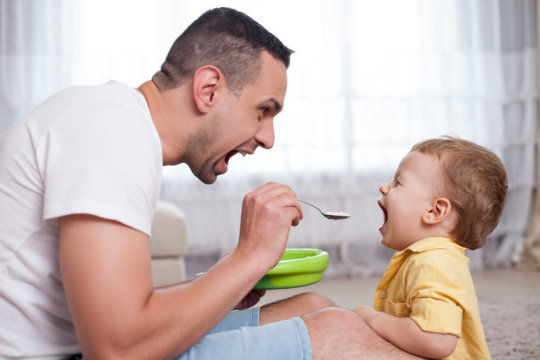 Father feeding child