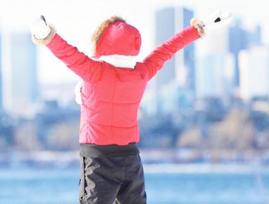 beat winter blues woman in jacket standing by water