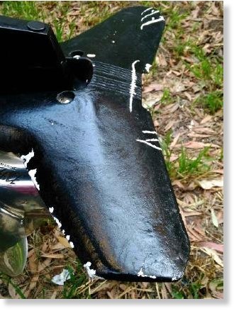 Click to enlarge A great white shark left teeth marks on the outboard motor
