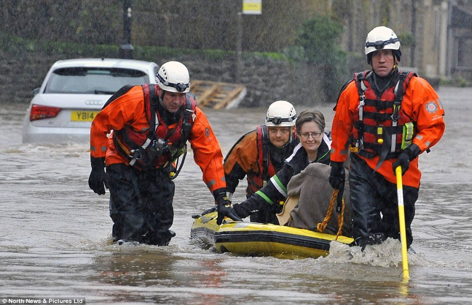 Emergency services rescue residents from flooded homes on King Street in Whalley, 