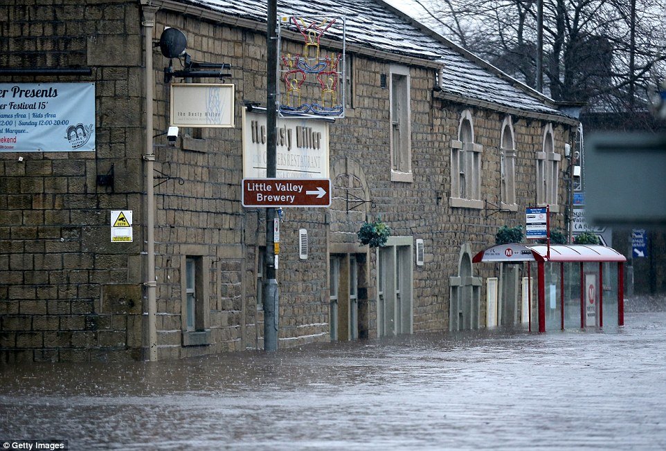 The River Calder bursts its banks in the Calder Valley town of Mytholmroyd,