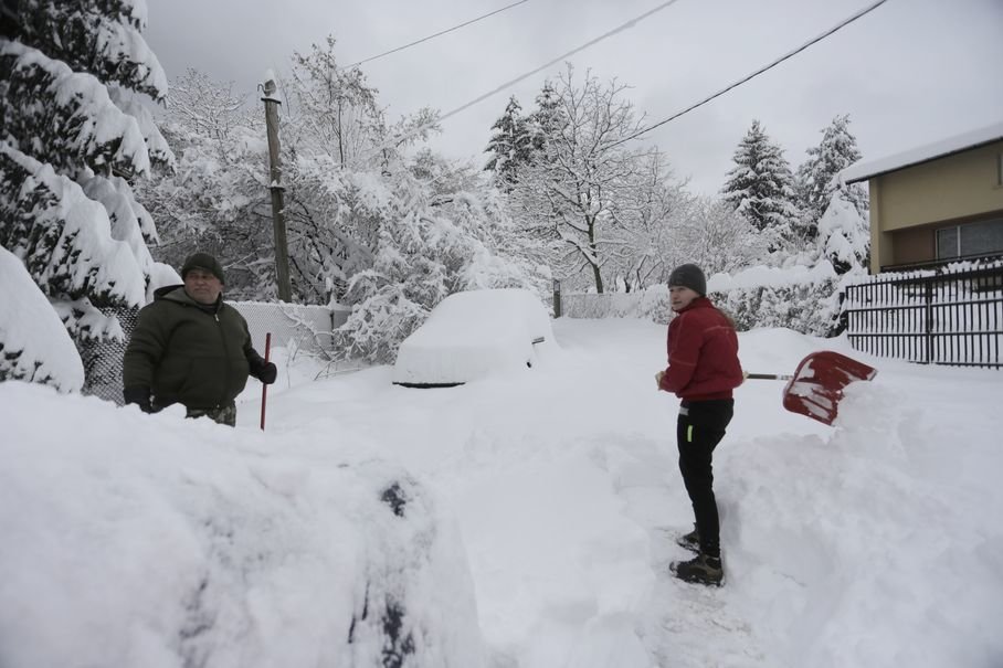 Sofia residents dig their cars out from the heavy snow in Sofia, Bulgaria