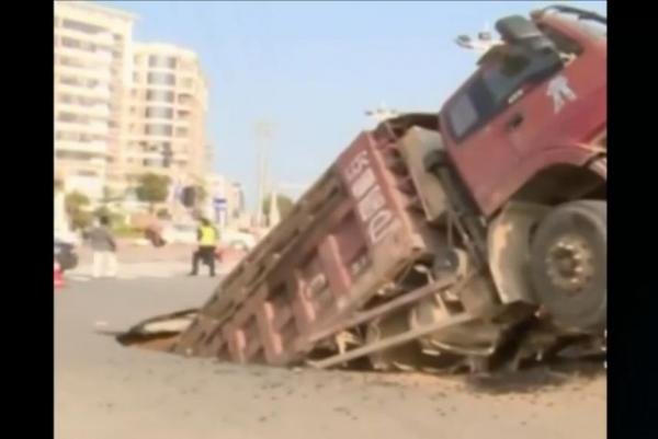 TRUCK IN SINKHOLE