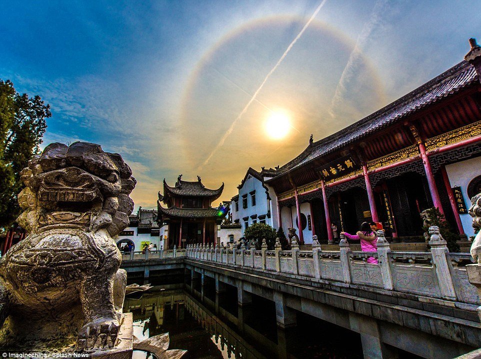 Stunning sun halo appears in sky over Buddhist Temple in 