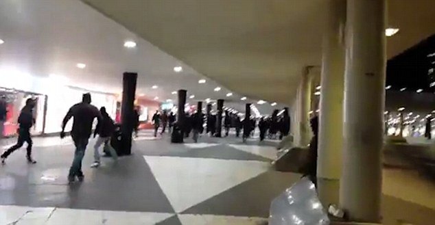 Click to enlarge Mob of black-clad masked men went on a rampage in and around Stockholm's main train station targeting refugee children