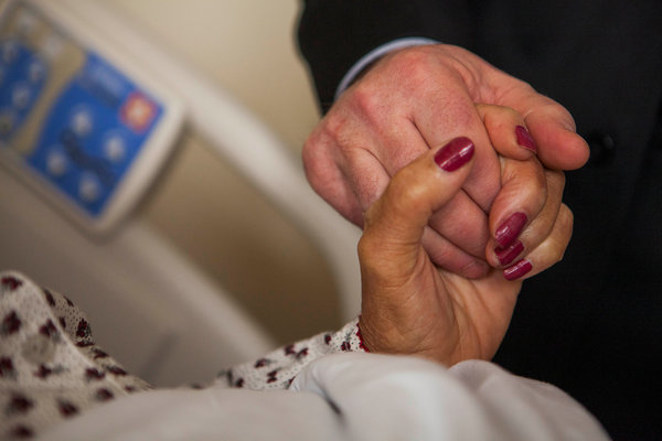 Holding hands of the dying