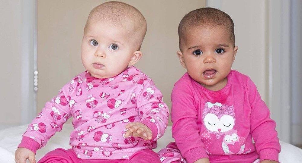 twin girls with different skin tones