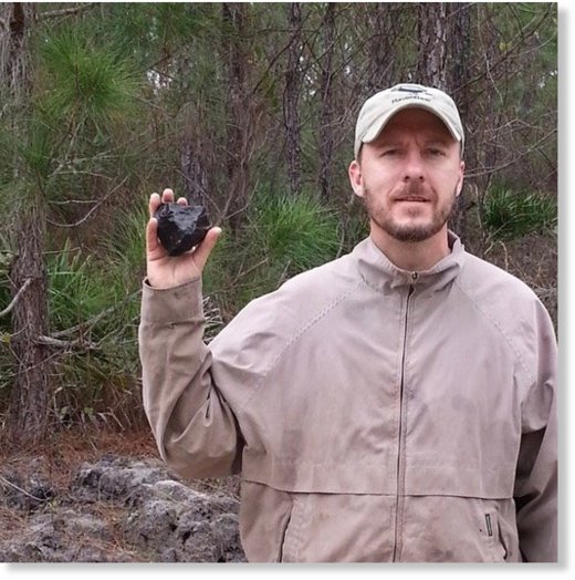 Josh Adkins holds up an 800-gram meteorite