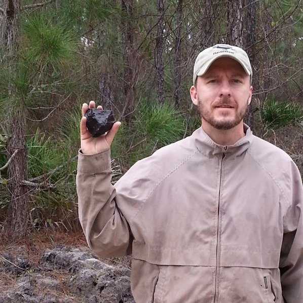 Josh Adkins holds up an 800-gram meteorite