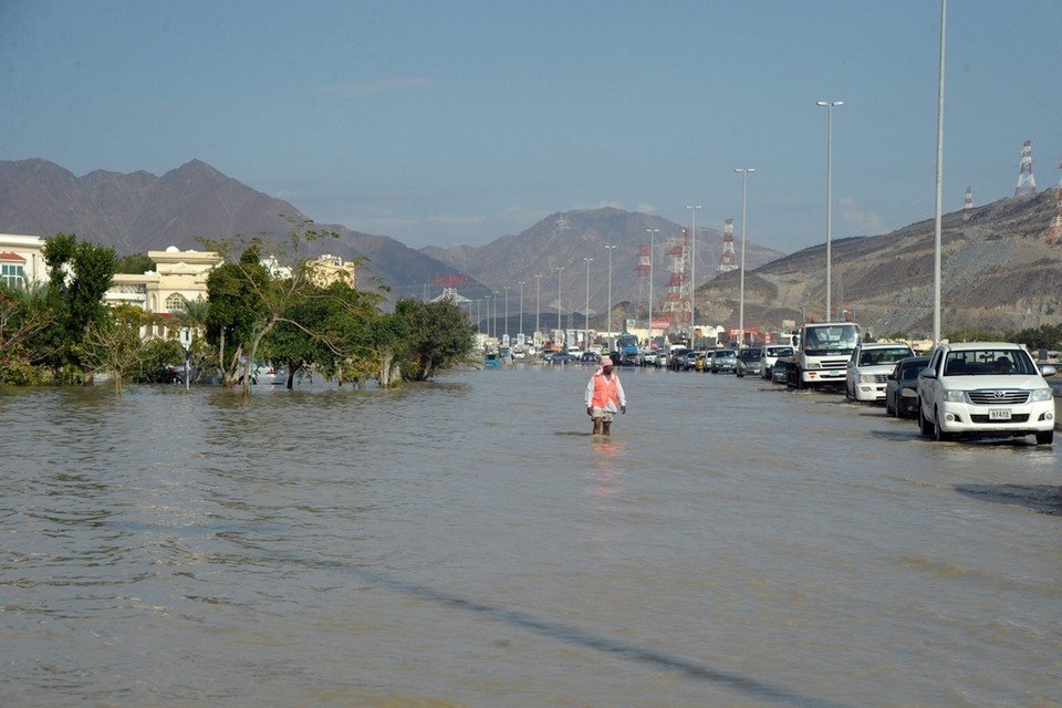 A man wades through a flooded street in Fujairah.