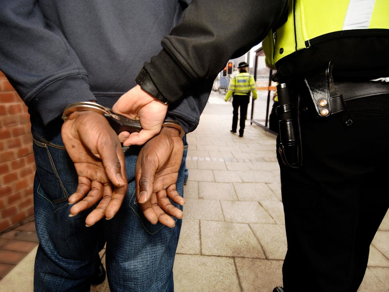 Click to enlarge Handcuffed brown person