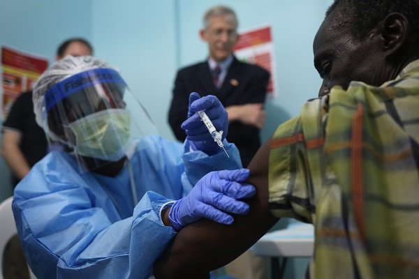 nurse administers an Ebola vaccine