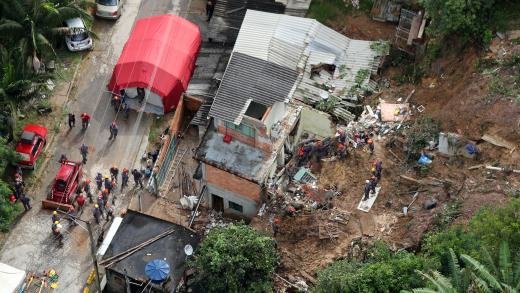 Click to enlarge Heavy rains paralyzed Latin America’s largest city and damaged other municipalities in the region. Above: firefighters and other first responders search for survivors at houses destroyed by landslides in in Mairipora, in the north of São Paulo state, Bra
