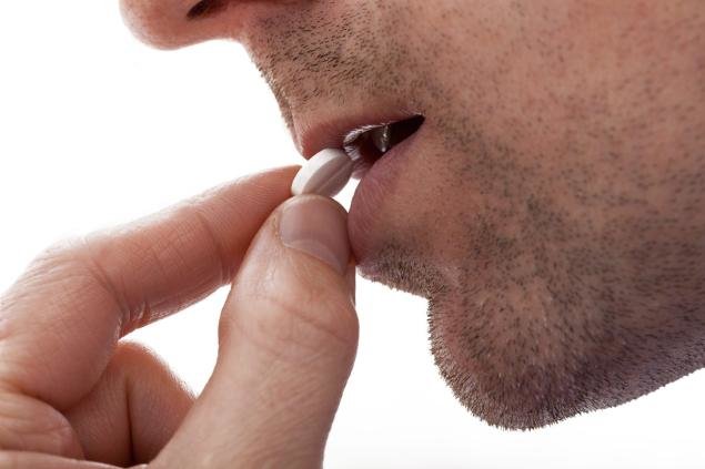 Click to enlarge man taking pill