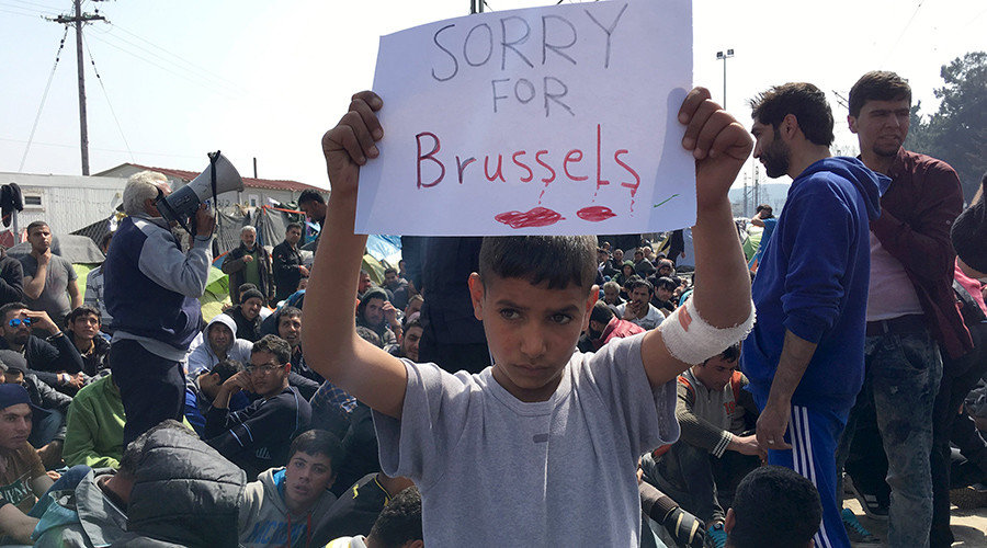 Refugee boy with sign for Brussels