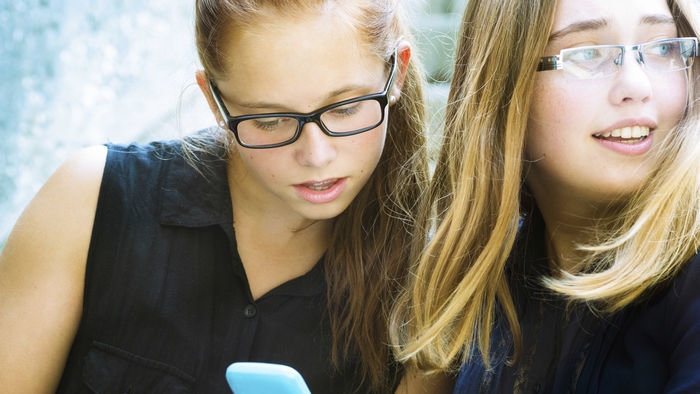 Click to enlarge teens using cellphone