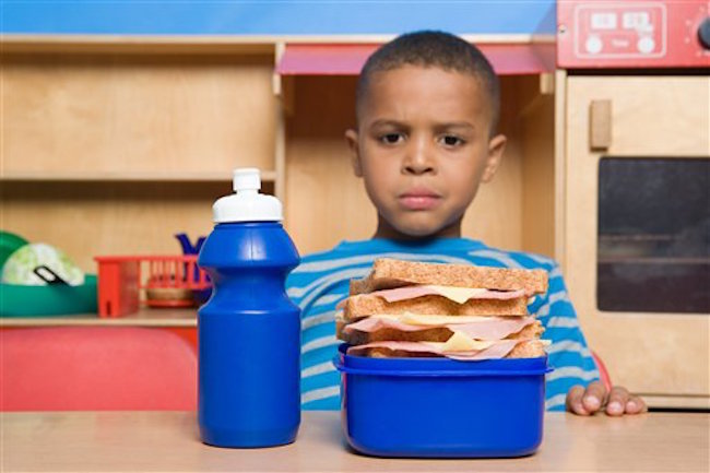 Click to enlarge child eating lunch