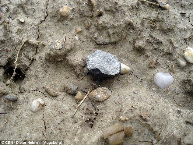 Click to enlarge By analysing images of the entry, researchers were able to locate the impact point and find fragments on the ground, in total weighing 40g (pictured centre)