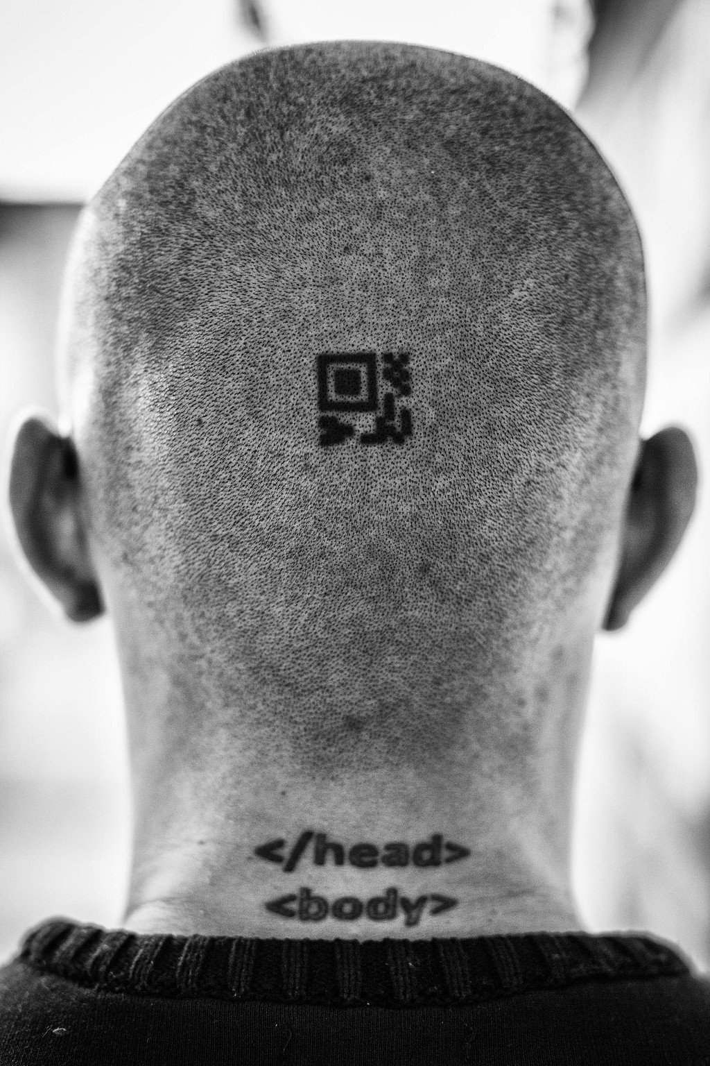 Click to enlarge Sepúlveda’s head. The upper tattoo is a QR code containing an encryption key.