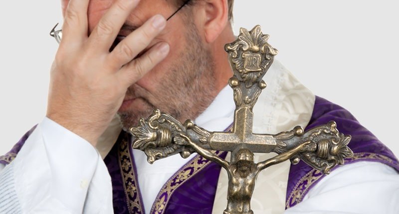 Catholic priest covering face