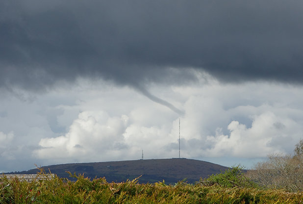 As the clouds swirled, Alan saw a funnel take shape. 