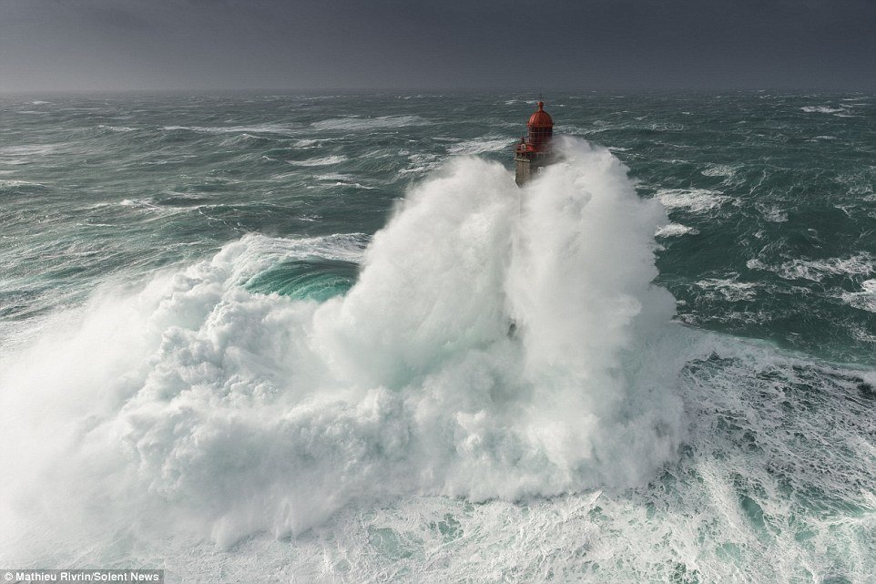 Click to enlarge The huge swell engulfs the entirety of the island lighthouse, meaning the enormous wave was as high as 11 double-decker buses