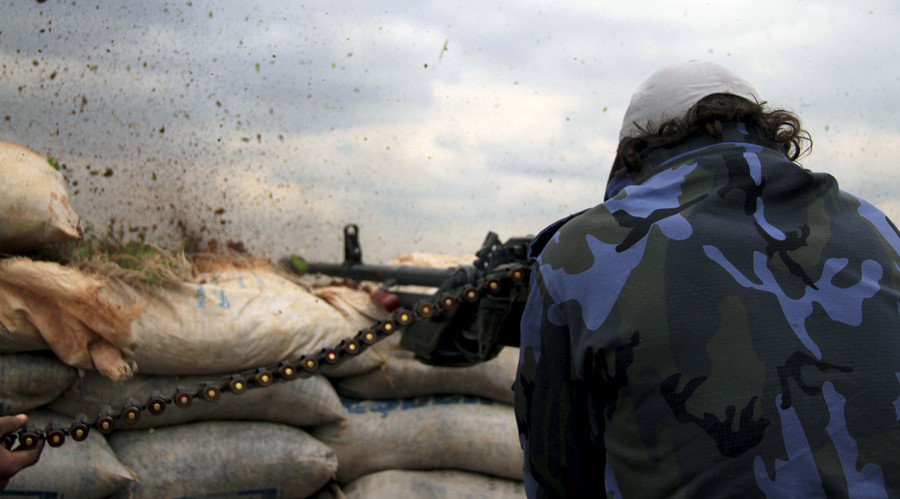 man firing machine gun