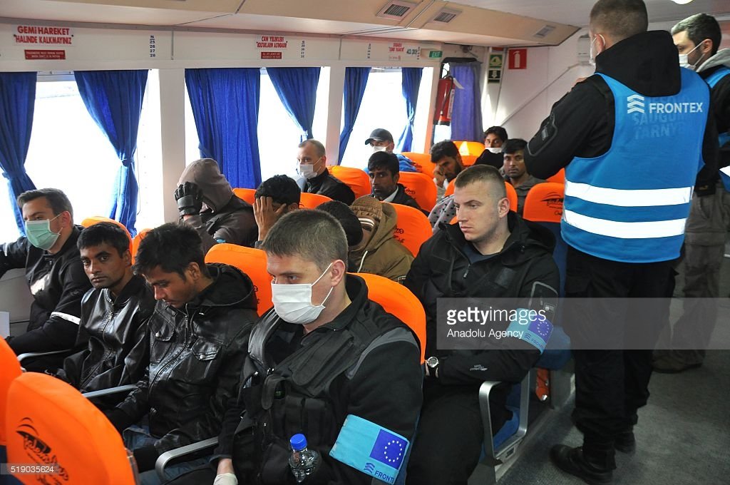 Frontex guards escorting refugees