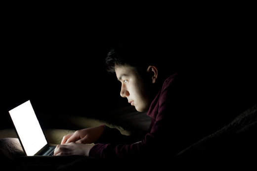 guy staring at computer late at night