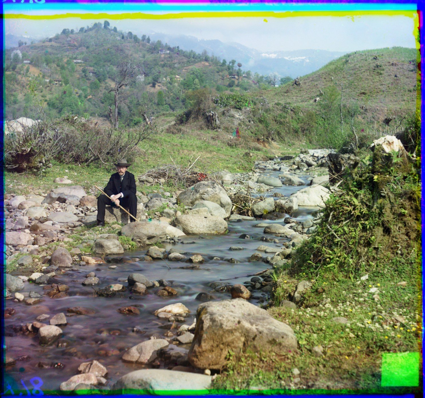 Sergei Mikhailovich Prokudin-Gorskii sits beside the Karolitskhali River. (1912)