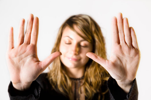 Click to enlarge woman holding her hands up saying no