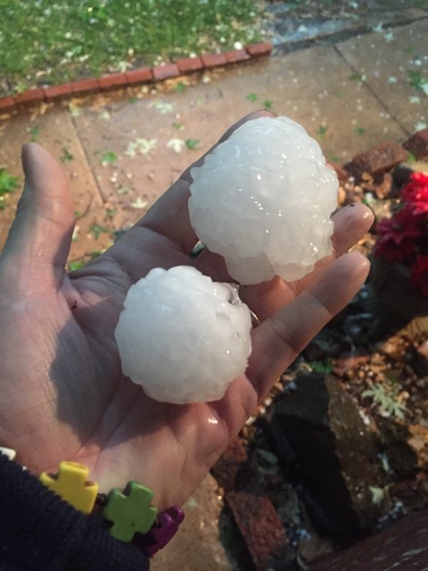 Susan Goodwyn holds hail in her hand Tuesday, April 26, 2016, in Wichita, Kan.