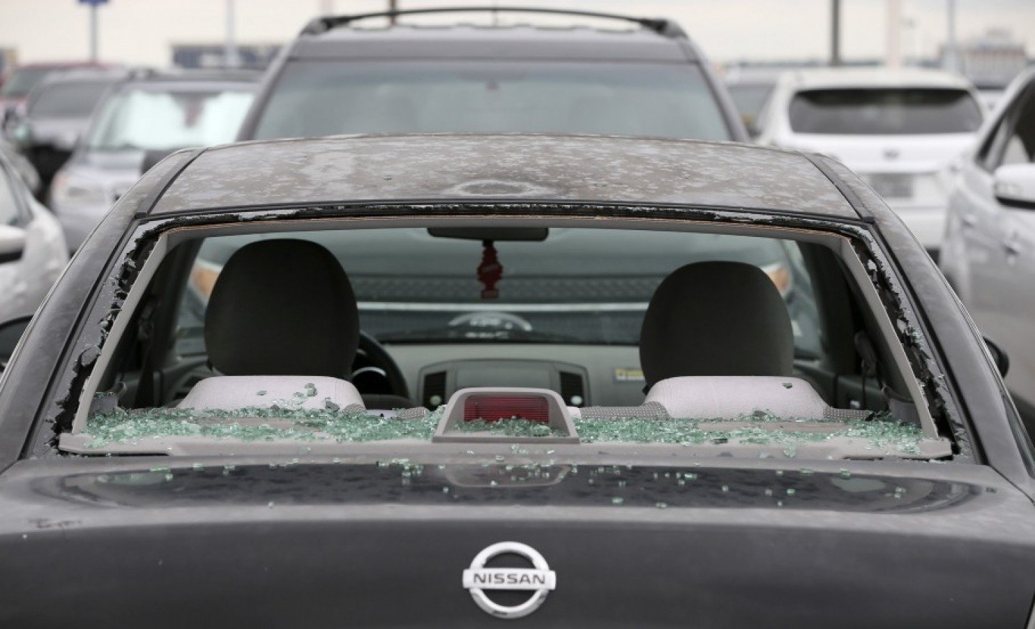 Some cars such as this Nissan were damaged at the San Antonio International Airport after a hail storm passed through the area recently on April 13, 2016. 