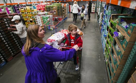 Kimberly Fee pushes a shopping cart holding her son, Cameron, 4, at Costco in Issaquah. Costco is working to boost its supply of organics.