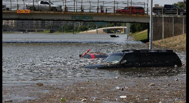 Vehicles are left stranded on Texas State Highway 288 in Houston, Texas on May 26, 2015.  