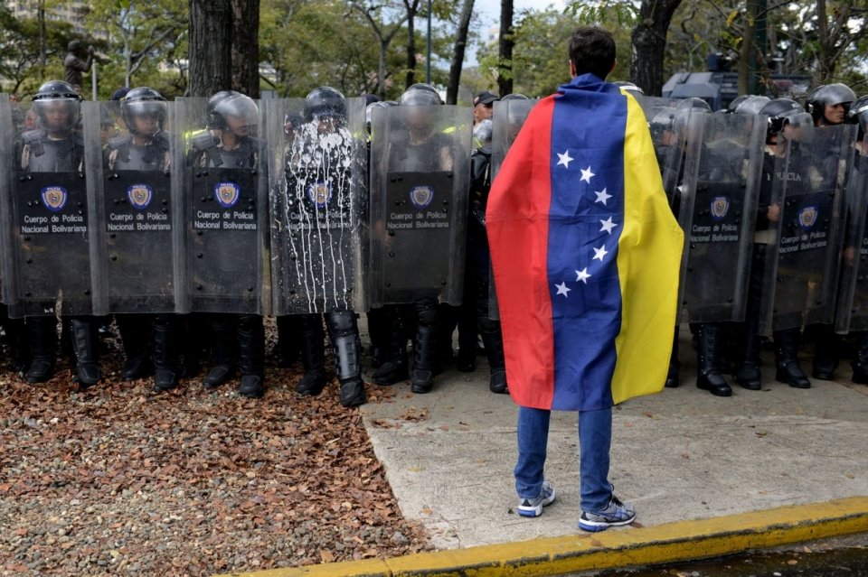 Protestor wearing Venezuela flag