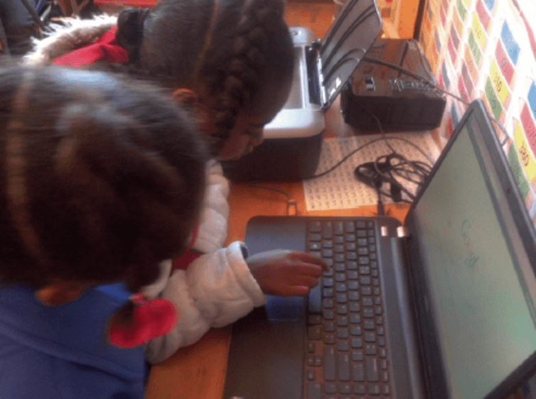 Click to enlarge children reading computer