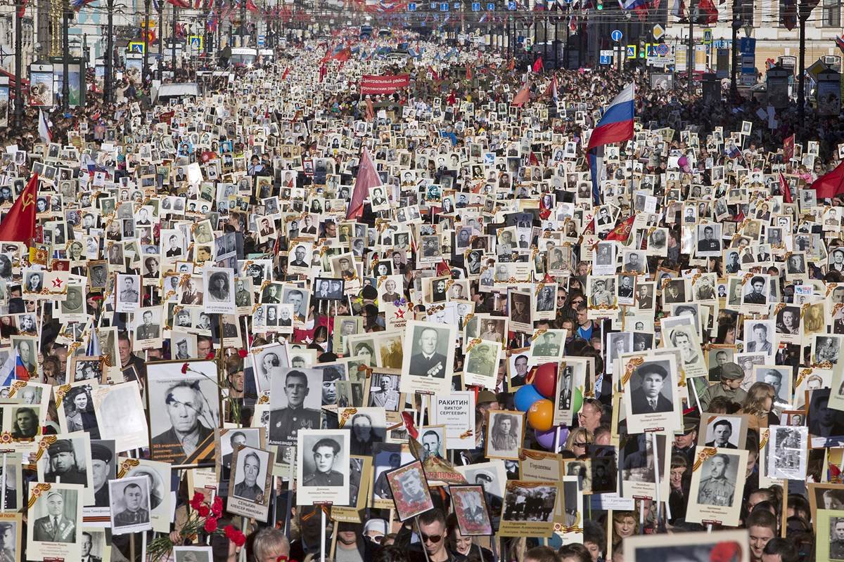 Click to enlarge Local residents carry portraits of their ancestors and participants in World War Two as they celebrate the 70th anniversary of the defeat of the Nazis in St. Petersburg