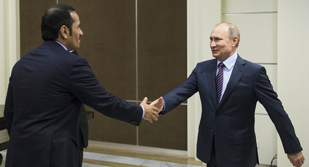 Russian President Vladimir Putin, right, shakes hands with Qatar Foreign Minister Mohammed bin Abdulrahman bin Jassim Al-Thani 