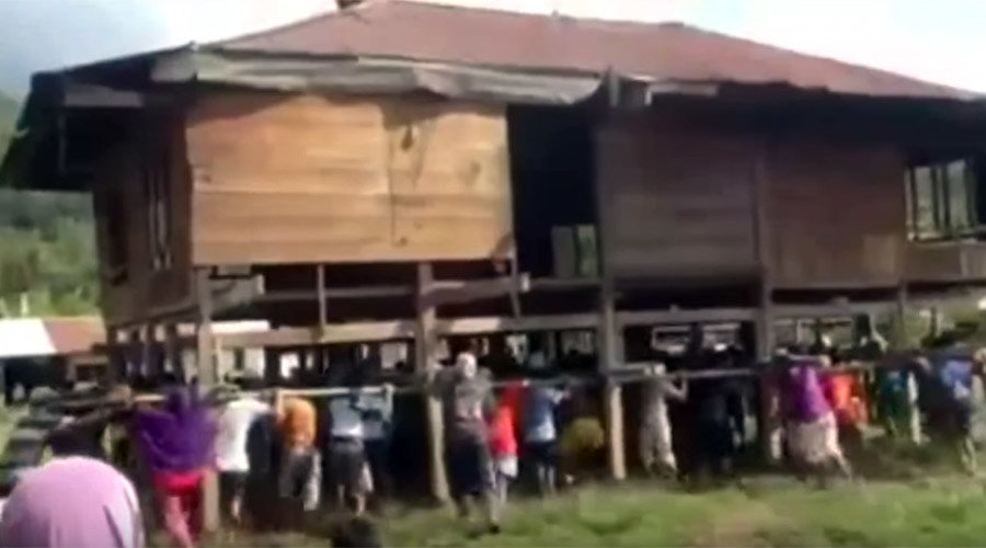Villagers move house by hand