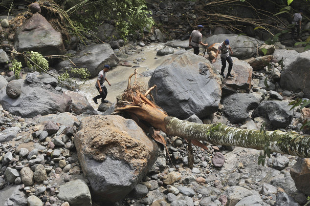 Click to enlarge Rescuers search for victims after a flood hit Dua Warna waterfall in Sibolangit, North Sumatra, Indonesia, Monday, May 16, 2016. Nearly two dozen students were missing in rain-triggered floods and landslides at the waterfall which is popular tourism attra
