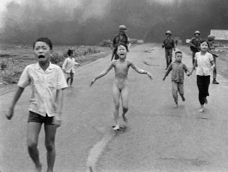 CIA-backed South Vietnamese forces follow after terrified children, including 9-year-old Kim Phuc, center, as they run down Route 1 near Trang Bang after an aerial napalm attack on suspected Viet Cong hiding places on June 8, 1972