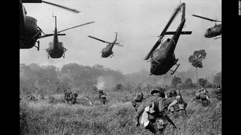 U.S. Army helicopters pour machine gun fire into tree line to cover the advance of South Vietnamese ground troops in an attack on a Viet Cong camp near the Cambodian border, in March 1965 during the Vietnam War.
