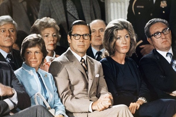 Treasury Secretary William Simon, left, sits with Nancy Kissinger and Secretary of State Henry Kissinger