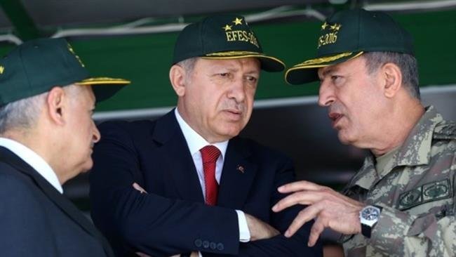Turkey's President Recep Tayyip Erdogan, center, and Prime Minister Binali Yildirim, left, listen to Chief of Staff Gen. Kayhan Ozer.
